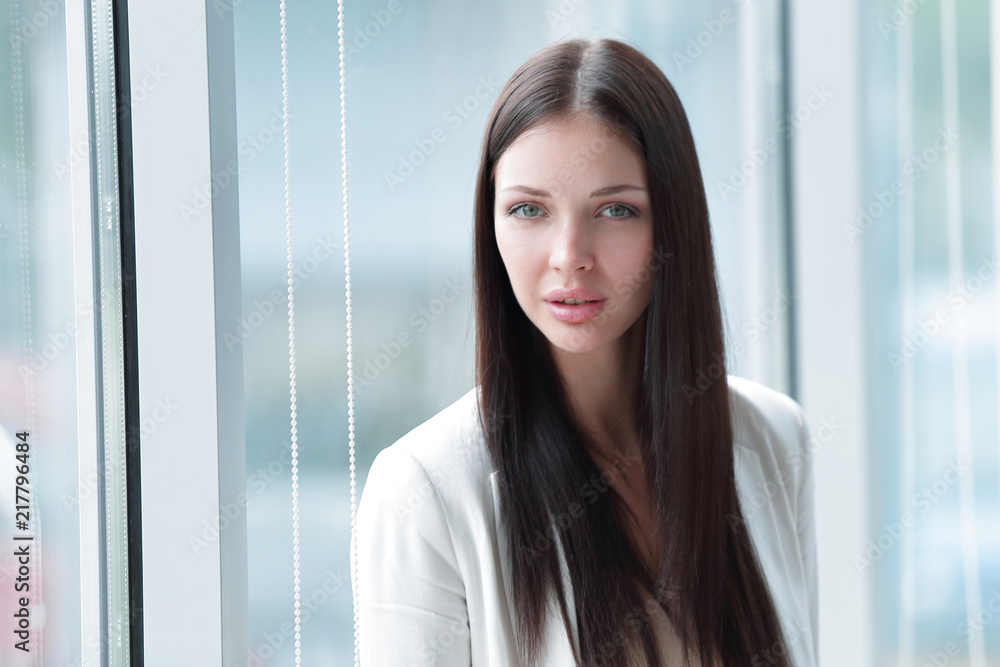 closeup.young business woman standing near the window in the office closeup.young business woman standing near the window in the office