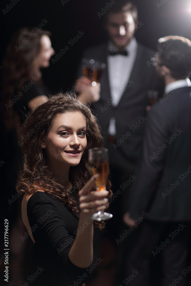 stylish young woman raising a glass of champagne