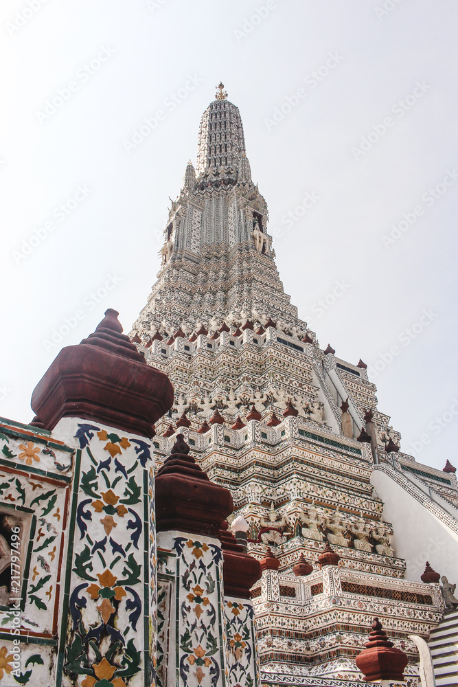 Detail of intricate ceramic wall with stupa as background in Wat Arun. Bangkok, Thailand.
