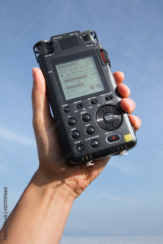 portable audio recorder in hand recording ambient sounds of nature portable audio recorder in hand recording ambient sounds of nature