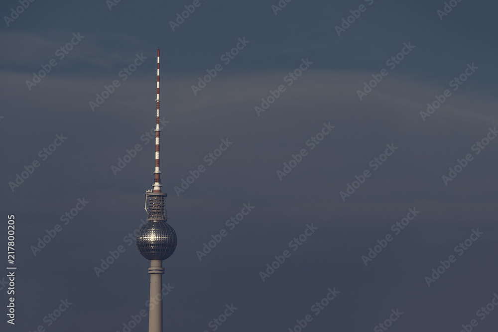 TV Tower In Berlin, Germany Against A Dark Blue Cloudy Sky