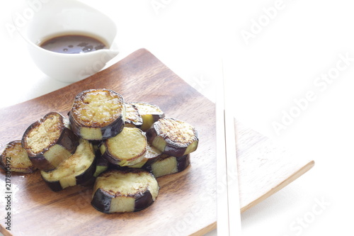 Asian food, pan fried eggplant on wooden plate photo