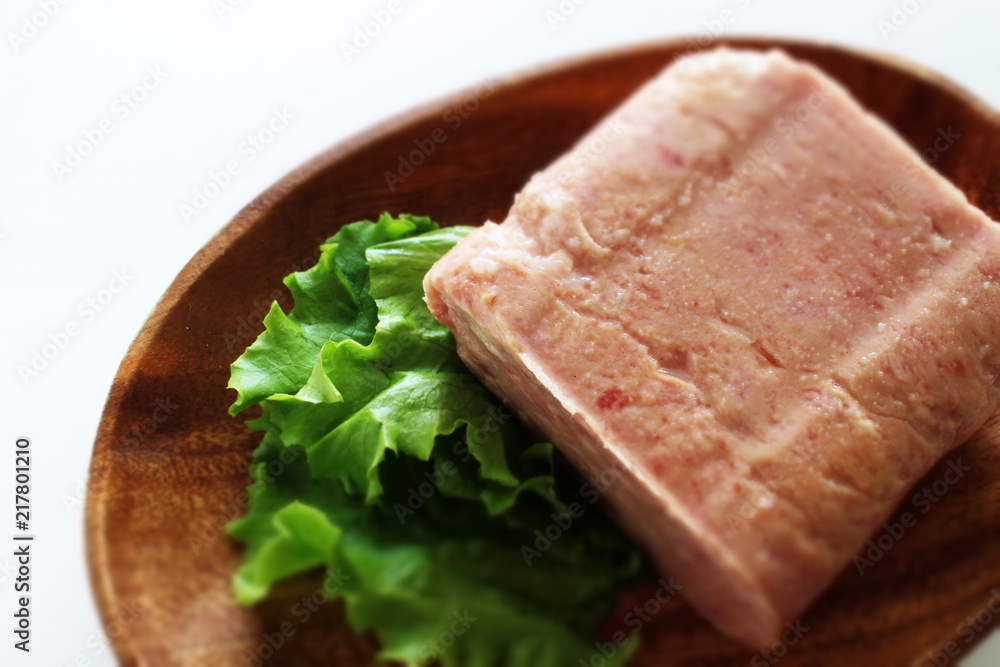 Canned food, luncheon meat on wooden plate