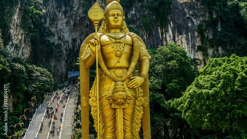 Lord Murugan Hindu Deity Statue at Batu Caves and tourist flow in Malaysia Time Lapse 4K photo