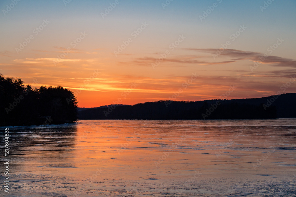 Sunset on frozen lake