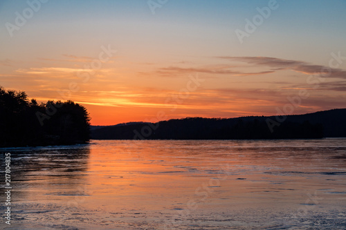 Sunset on frozen lake