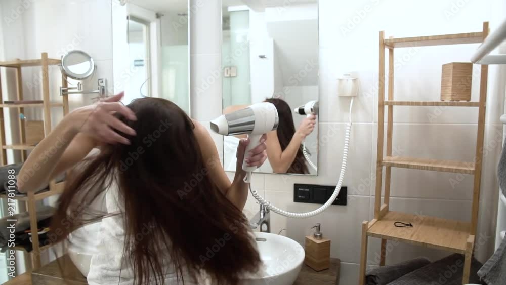 Hair Care. Woman Drying Long Hair With Hairdryer At Bathroom Hair Care. Woman Drying Long Hair With Hairdryer At Bathroom