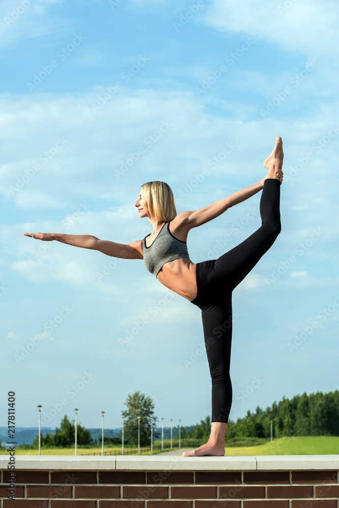 Young blonde doing yoga out-of-doors shot Young blonde doing yoga out-of-doors shot