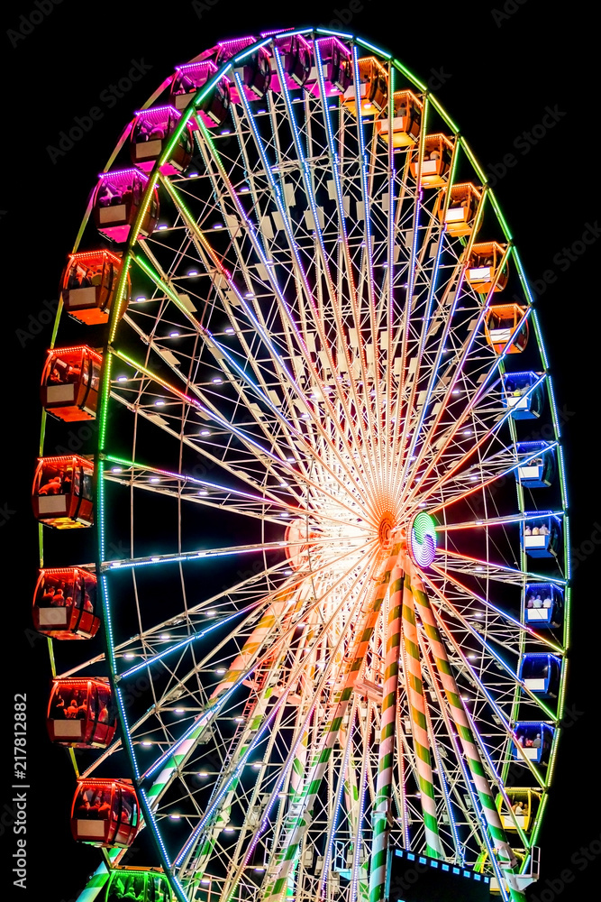 Ferris Wheel Spinning Round Illuminated in Night Sky