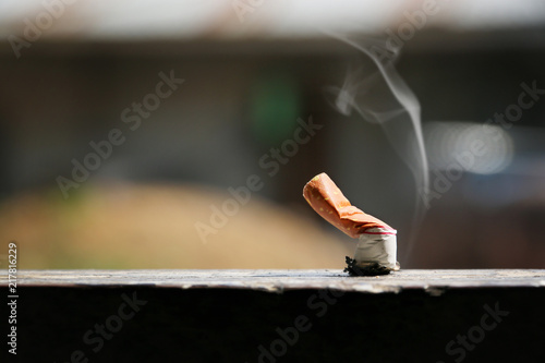 Brown color filter bottom cigarette on wooden floor. photo