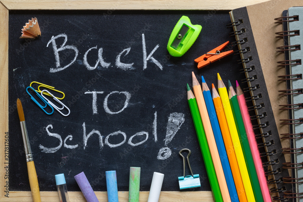 Freehand writing Back to school letters on chalkboard with School supplies Freehand writing Back to school letters on chalkboard with School supplies