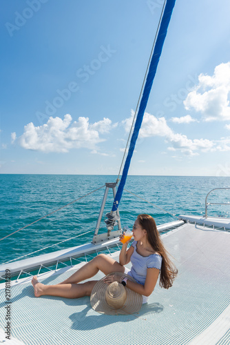 Lifestyle series: Asian woman relaxing on catamaran yacht