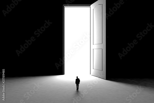 Success concept with businessman, Image of miniature businessman standing in front of open door on black wall background, 3D rendering © krung99