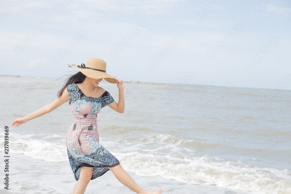 Thai girl enjoy and happy her relaxing on the beach, Hua Hin, Thailand