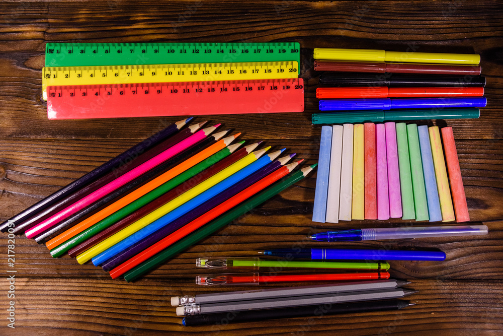 Obraz premium Different school stationeries on a dark wooden table