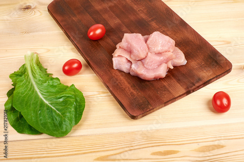 Raw turkey fillet pieces on a cutting board wooden background photo