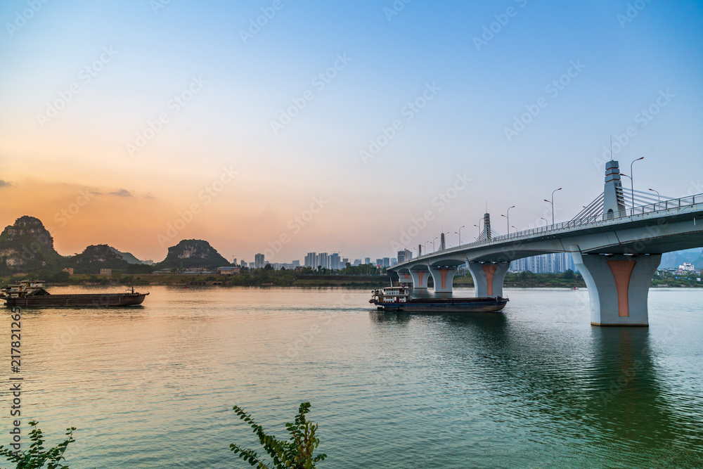 Bridges in the evening and cargo ships on the surface