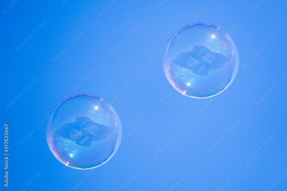 Soap bubbles in flight against the blue sky Soap bubbles in flight against the blue sky