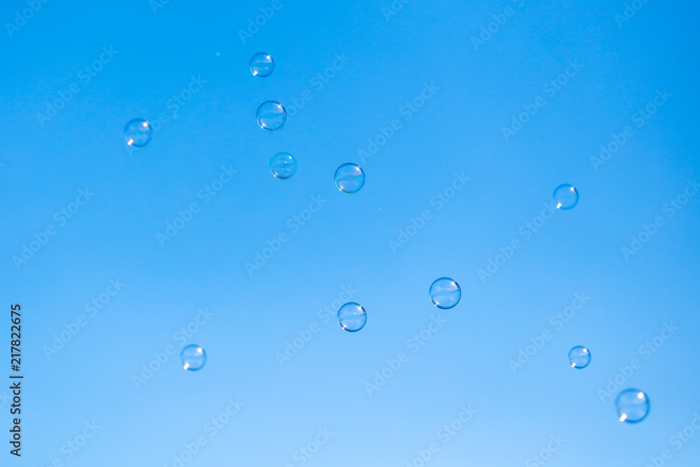 Soap bubbles in flight against the blue sky Soap bubbles in flight against the blue sky