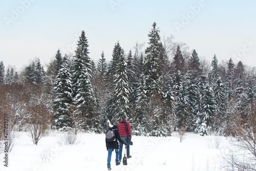 Tourists go to winter forest