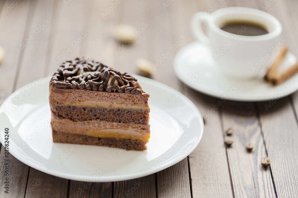 Dessert souffle with chocolate sauce and nuts on a white plate, on a wooden table. Dessert souffle with chocolate sauce and nuts on a white plate, on a wooden table.