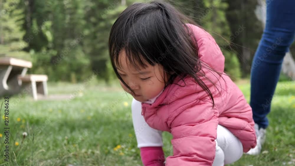 Asian Chinese Toddler and mother playing in a park Asian Chinese Toddler and mother playing in a park