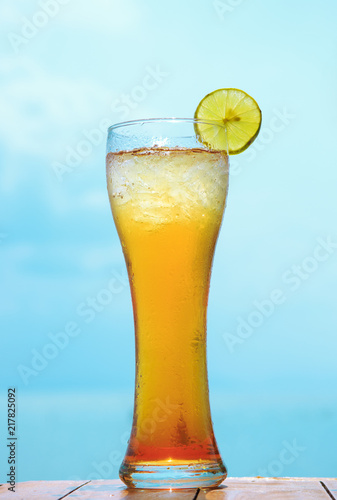 glass of ice tea on tropical background
