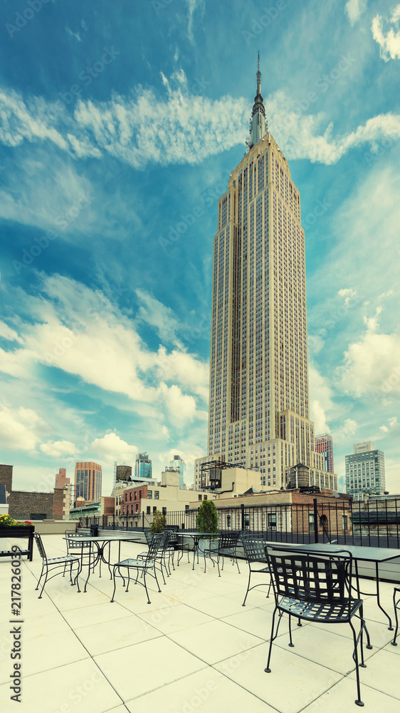 Naklejka premium Kawiarnia na dachu z widokiem na Empire State Building, Manhattan, New York City. Przetwarzane w stylu vintage.