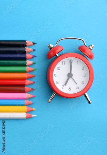 Back to school concept. Pencils and clock