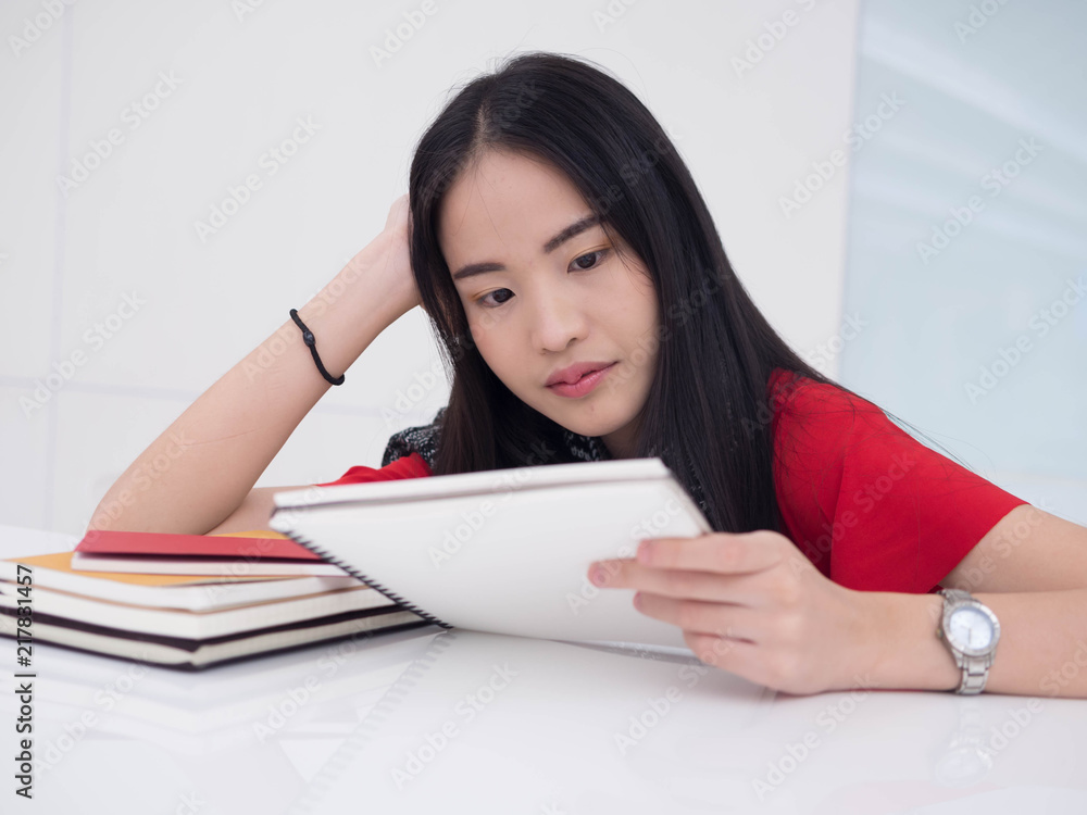 Young Asian female student with notebooks in her hands.A portrait of an Asian college student.education and learning concept. Young Asian female student with notebooks in her hands.A portrait of an Asian college student.education and learning concept.