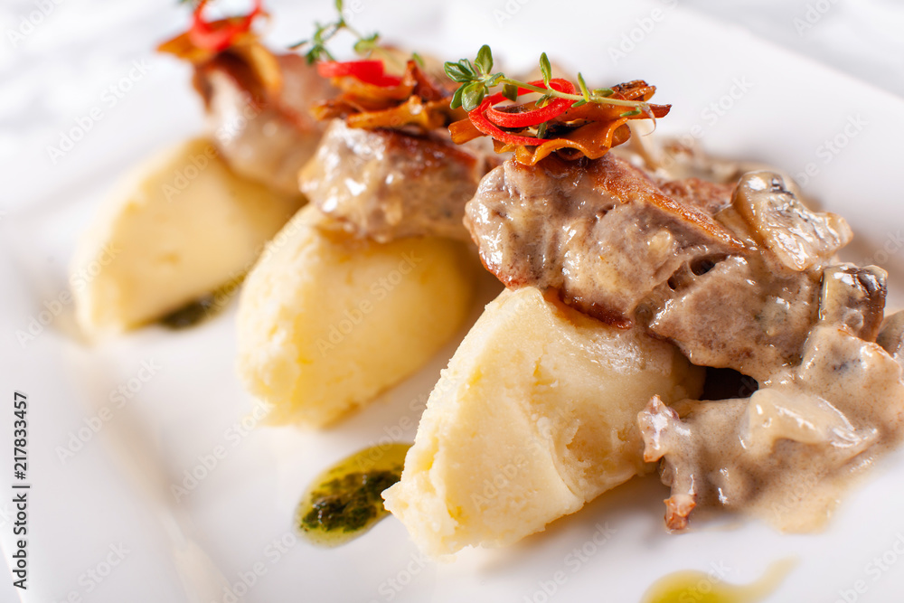 Pork Medallions with Mashed Potato and Mushrooms. Pork tenderloin on a white plate, good serving. restaurant menu Pork Medallions with Mashed Potato and Mushrooms. Pork tenderloin on a white plate, good serving. restaurant menu
