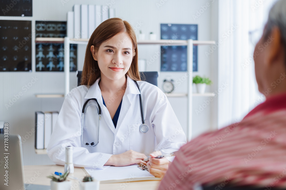 Young asian woman doctor discussing with old patient for consulting and diagnose at hospital, asian medical concept Young asian woman doctor discussing with old patient for consulting and diagnose at hospital, asian medical concept