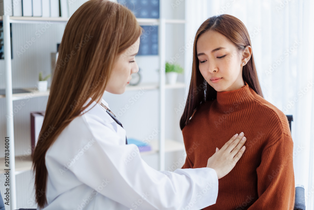 Fototapeta premium Asian doctor woman examining mammography young woman for breast cancer at hospital, asian medical concept