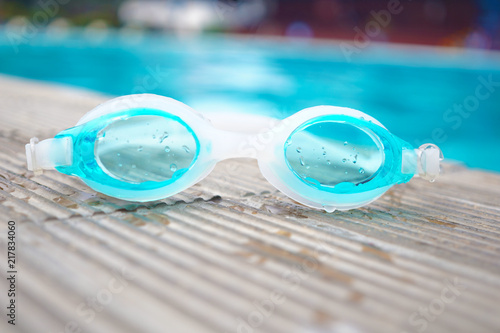 Swimming goggles at poolside