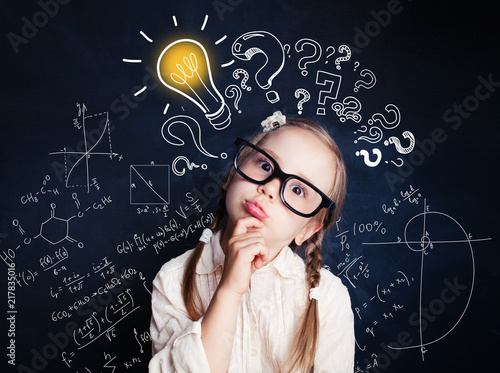 Small child mathematics student thinking on background with lightbulb and math formulas. Kid ideas photo