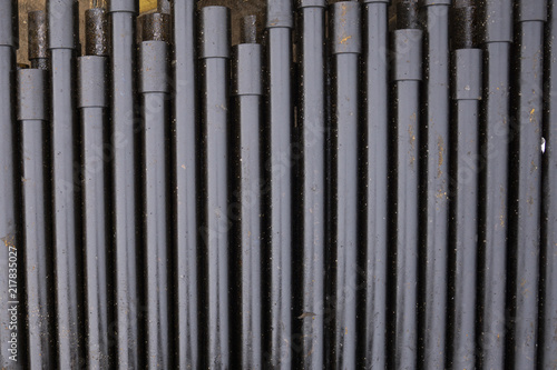 Oil Drill pipe. Rusty drill pipes were drilled in the well section. Downhole drilling rig. Laying the pipe on the deck. View of the shell of drill pipes laid in courtyard of the oil and gas warehouse.