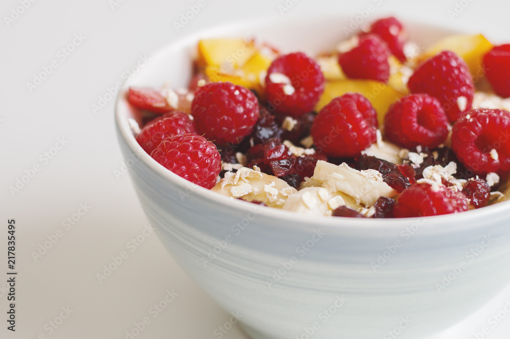 Fruit salad with raspberry, nectarine, banana, plum, dried cranberry and oats. Oats porridge with fruits and berries. Healthy eating concept Fruit salad with raspberry, nectarine, banana, plum, dried cranberry and oats. Oats porridge with fruits and berries. Healthy eating concept