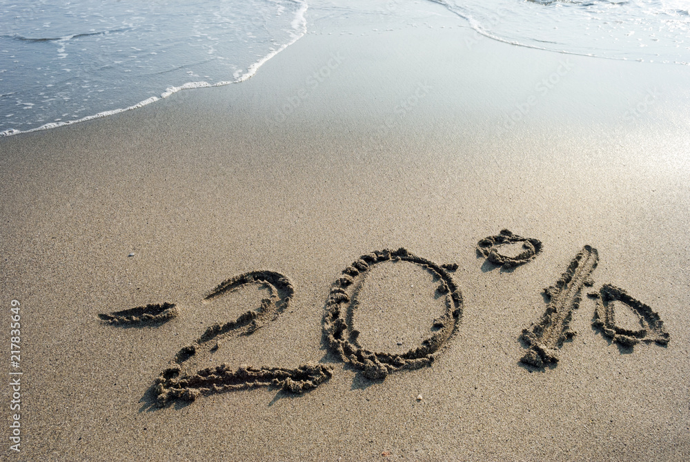 Fototapeta premium inscription on the sand minus twenty percent, 20 %, sea wave on the sand with the inscription twenty