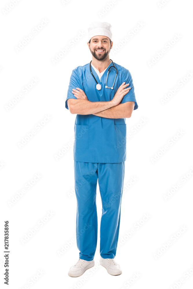 full length view of bearded surgeon standing with crossed arms and smiling at camera isolated on white full length view of bearded surgeon standing with crossed arms and smiling at camera isolated on white