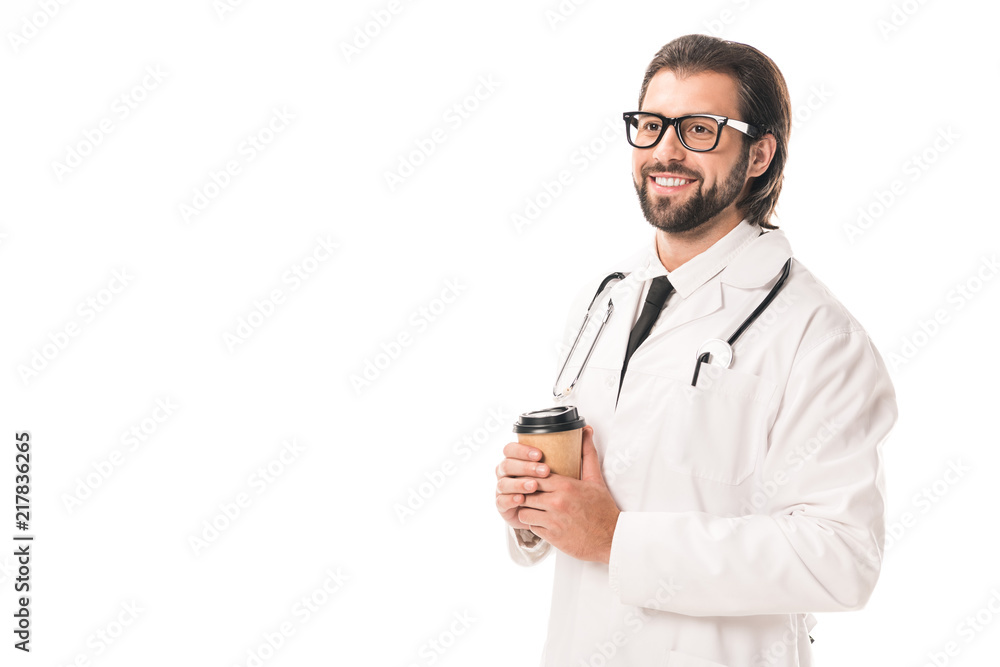 handsome smiling doctor holding coffee to go and looking away isolated on white handsome smiling doctor holding coffee to go and looking away isolated on white
