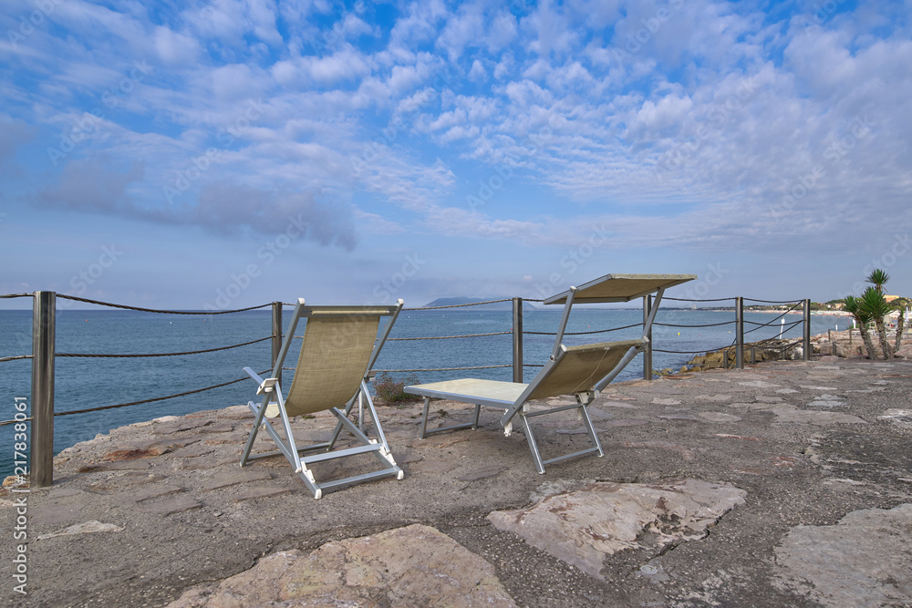 sandy beach along the sea, bathing people and playing children