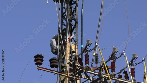 Electricians fixing high voltage electrical lines, replacing a transformer