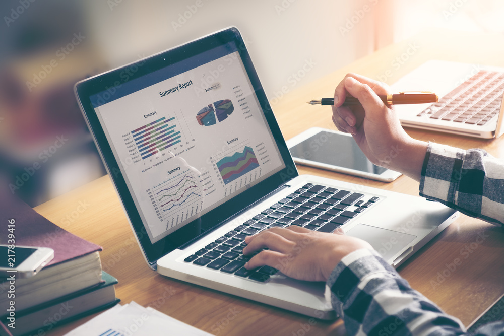 Business woman analyzing investment charts in laptop screen at morning time. Business woman analyzing investment charts in laptop screen at morning time.