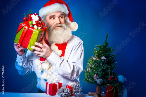 Santa Claus puts presents u...