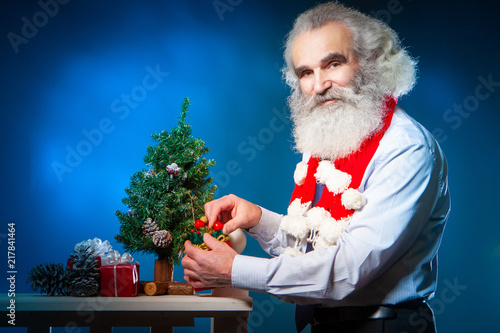 An elderly man decorates a ...