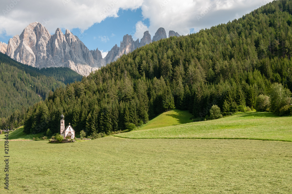 The Church of St. Johann in Ranui, in the Italian Dolomites, on a summer afternoon.