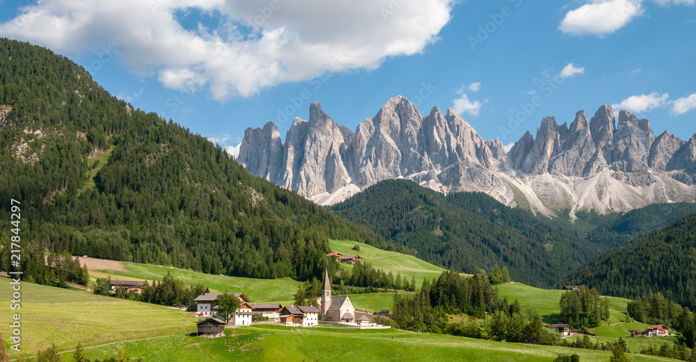 The famous Church of Santa Maddelena against the backdrop of the Italian Dolomites on a summer afternoon.