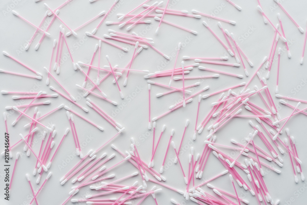 top view of scattered pink cotton swabs isolated on white, beauty concept top view of scattered pink cotton swabs isolated on white, beauty concept