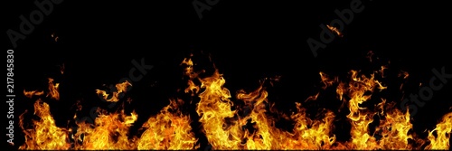 Real line of fire flames isolated on black background. Mockup on black of wall of fire. © Dancing Man