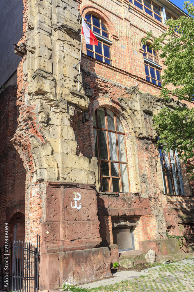 A preserved fragment of the historic facade of  Bank of Poland destroyed during World War II and the Warsaw Uprising at the corner of Bielanska and Danilowiczowska streets